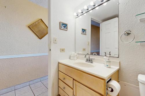a bathroom with a sink and a mirror at Island Sands Resort 103 in Maalaea