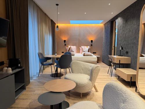 a hotel room with a bed and a table and chairs at Hotel Lotus in Reykjavík