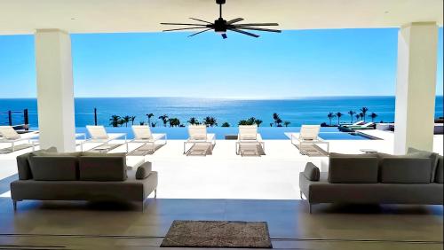 a room with chairs and a view of the ocean at Poco Paraiso in San José del Cabo