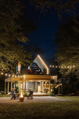 a house with a deck on top of it at night at The Alto in Logan