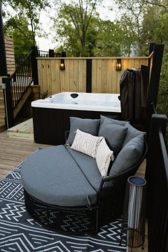 a bed sitting on a deck next to a bath tub at The Alto in Logan