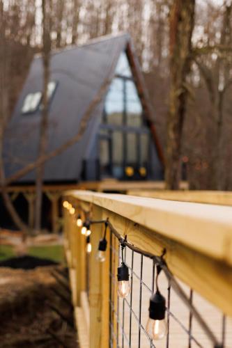 a wooden railing with lights on it with a house in the background at The Pinnacle in Logan