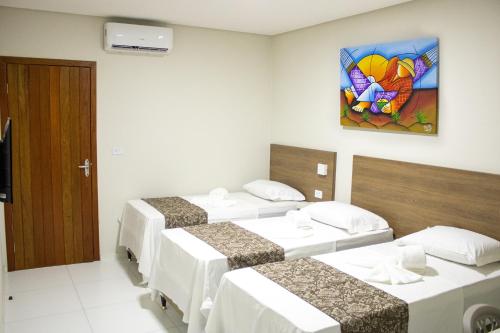 Ένα ή περισσότερα κρεβάτια σε δωμάτιο στο Paraiso Barra Hotel