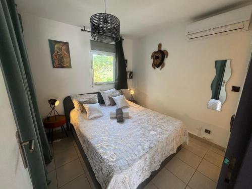 una camera da letto con un letto e una finestra di Kay lanmou location de vacances Sainte Anne a Sainte-Anne