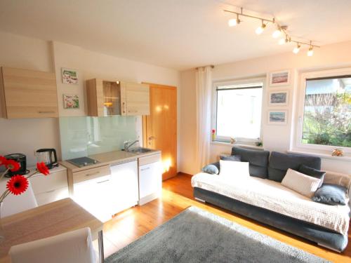 a living room with a couch and a kitchen at Apartment Muehlbach by Interhome in Fliess
