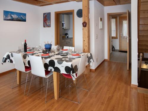 a dining room with a cow table and chairs at Apartment Racer's Retreat Apt-12 by Interhome in Wengen