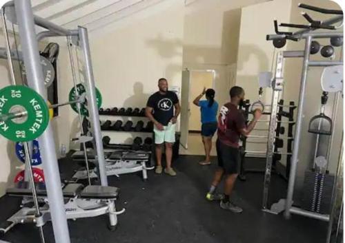 a group of people standing in a gym at Dowayne 1bed 1 bath in gated community colbeck manor in Old Harbour