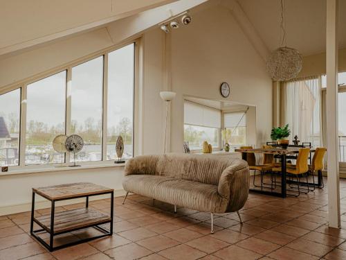 a living room with a couch and a table at Apartment Penthouse by Interhome in Uitgeest