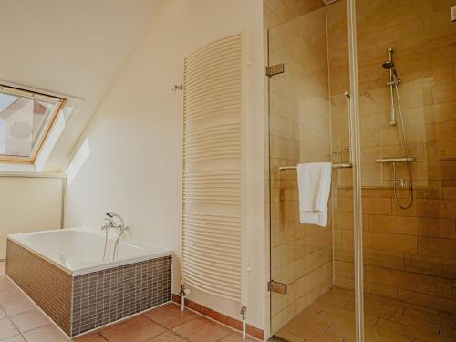 a bathroom with a shower and a bath tub at Apartment Penthouse by Interhome in Uitgeest