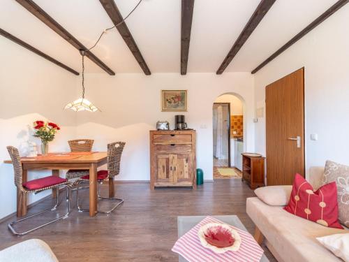 a living room with a table and a couch at Apartment Am Hohen Bogen-64 by Interhome in Kummersdorf