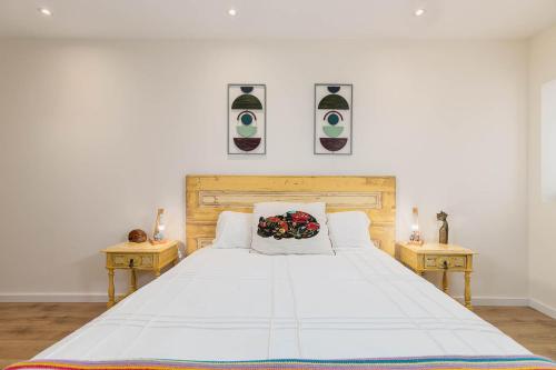 a bedroom with a large white bed with two tables at NEW! Charming Palmela Retreat near Arrábida&Castle in Palmela