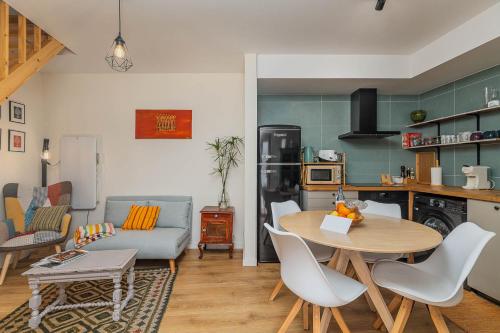 a kitchen and living room with a table and chairs at NEW! Charming Palmela Retreat near Arrábida&Castle in Palmela