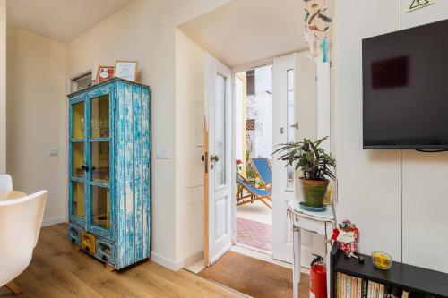 a living room with a blue cabinet and a tv at NEW! Charming Palmela Retreat near Arrábida&Castle in Palmela