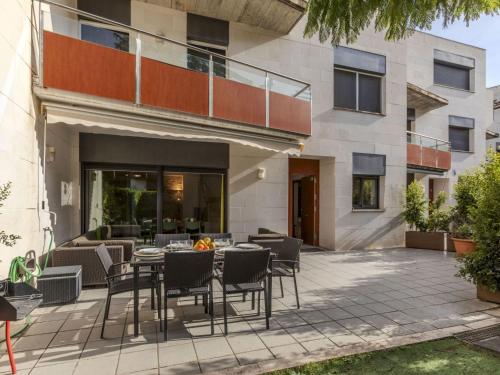 a patio with a table and chairs in front of a building at Holiday Home Sol Cambrils Park 28 by Interhome in Cambrils