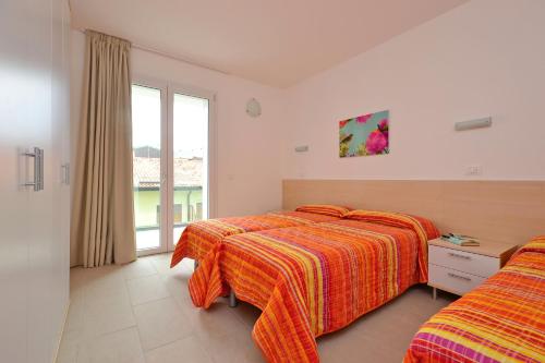 Postel nebo postele na pokoji v ubytování Appartamenti Fiore