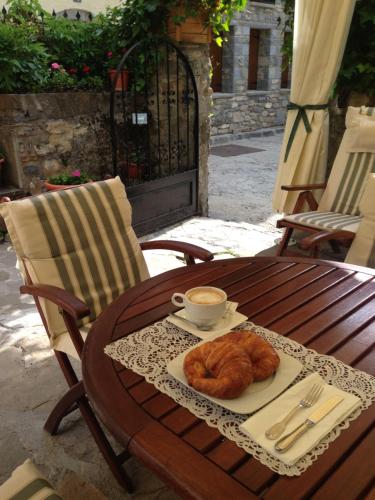 a plate of croissants and a cup of coffee on a wooden table at Hotel Casa Socotor in Sallent de Gállego