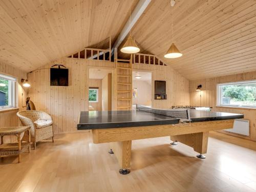a large room with a ping pong table in it at Holiday Home Dorde - 600m from the sea by Interhome in Rødby