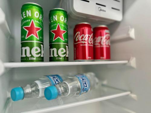 two cans of coca cola in a refrigerator at Pousada Mar de Corais in Serra