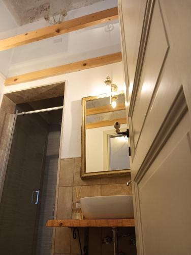 a bathroom with a sink and a mirror at Le Volte Sveve in Mesagne