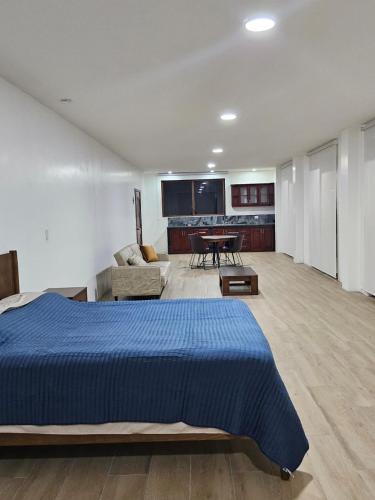 a bedroom with a bed and a living room at Carpe Diem Palora in Palora