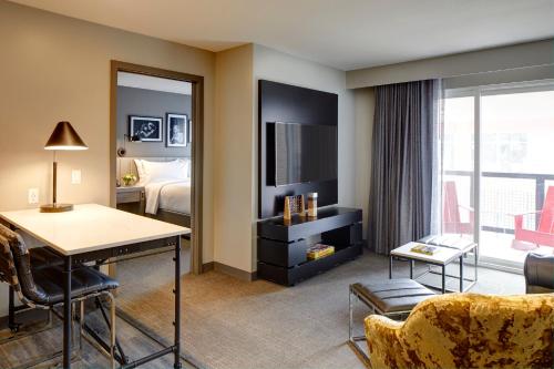 a hotel room with a desk and a bed at Archer Hotel Boston/Burlington in Burlington