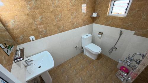 a bathroom with a toilet and a sink at Hotel Yatri in Pokhara
