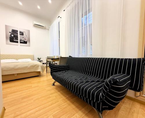 a living room with a couch and a bed at Kyiv Gelik Apartment in Kyiv