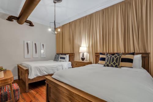 a hotel room with two beds and a table at Home at 1014 in Savannah