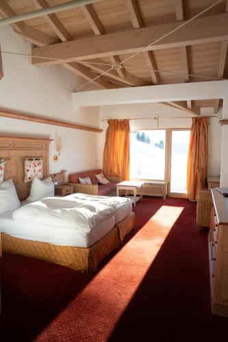 a bedroom with a large bed and a large window at Bergvital Hotel Todtnau in Todtnau