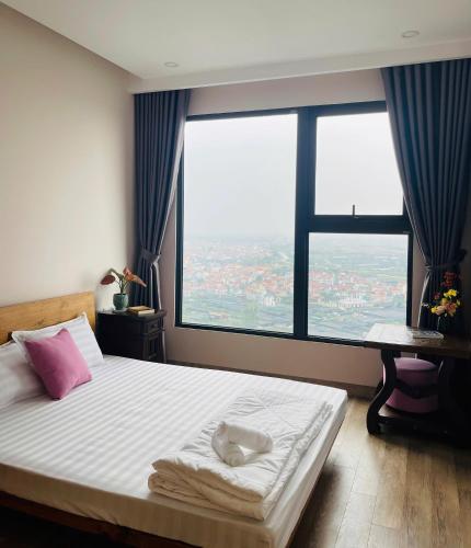 a bedroom with a bed with a large window at Nana Home in Kim Quan