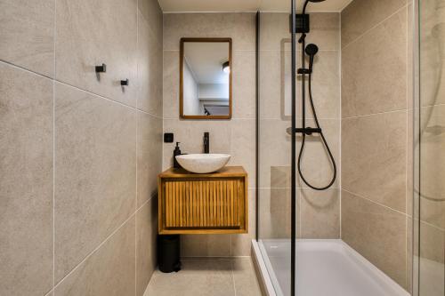 Steirerblicke City Apartments في غراتس: حمام مع حوض استحمام ومغسلة ودش