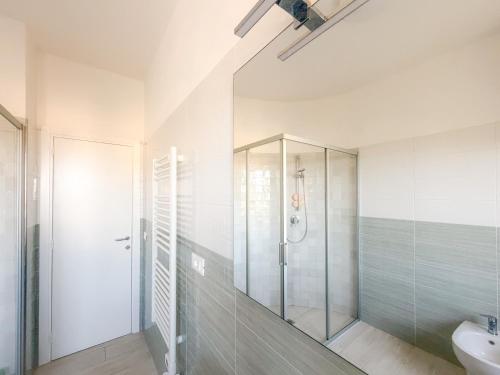 a bathroom with a glass shower and a sink at La Dimora di Bagnaja - HelloElba in Bagnaia