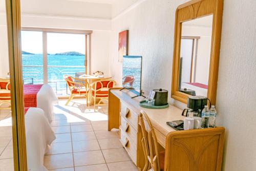 a kitchen with a sink and a mirror and a table at HOTEL SAN CARLOS PLAZA in San Carlos