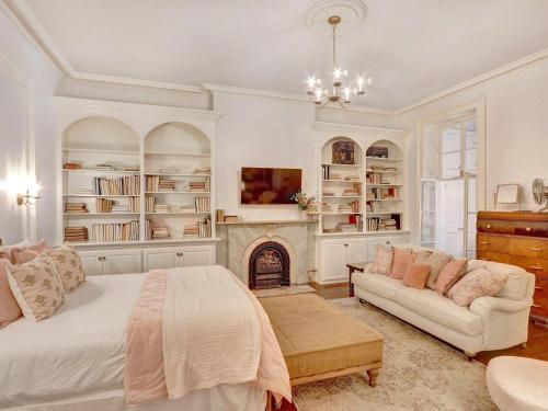 a bedroom with a bed and a fireplace at Elsewhere on Madison Square Main in Savannah