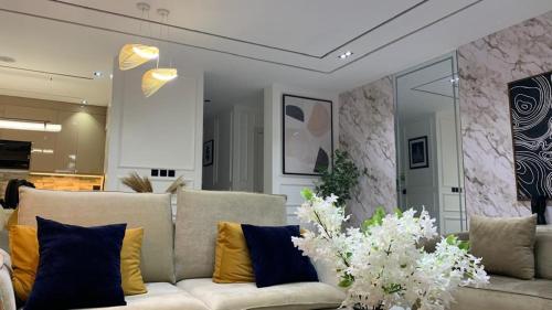 a living room with a couch and some flowers at Aklass Apartments in Lekki
