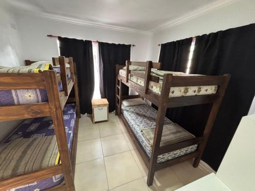 a room with three bunk beds and a window at Beach House and Nature in Aguas Verdes