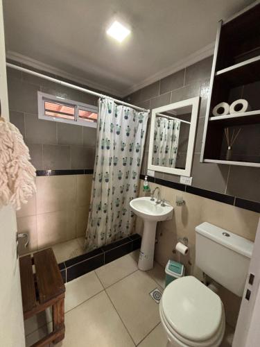 a bathroom with a toilet and a sink at Beach House and Nature in Aguas Verdes