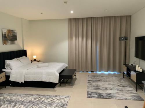 a hotel room with a bed and a television at Nuchi studio in Dubai