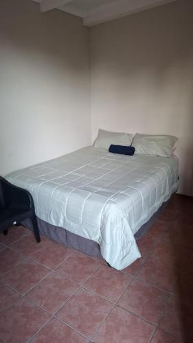 a bedroom with a bed with a bluevisorvisorvisorvisor at MDA Myburgh in Brackenfell