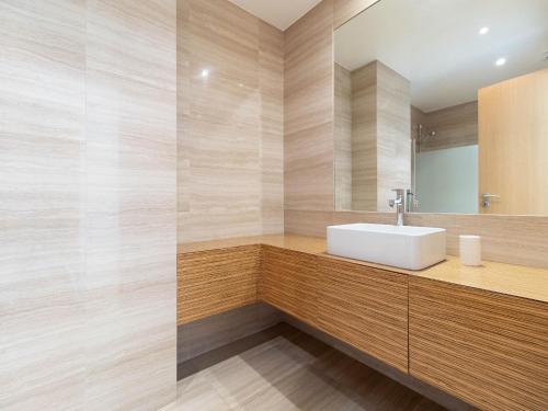 a bathroom with a sink and a mirror at Akicity Jamor Lyra in Cruz Quebrada