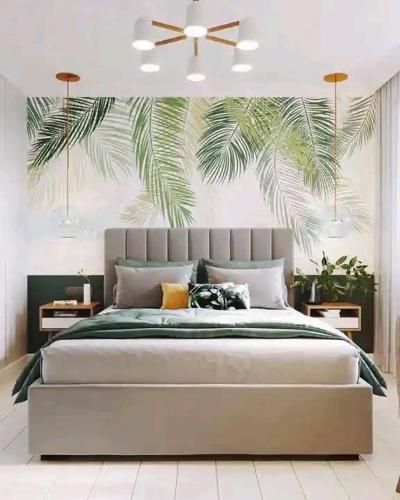 a bedroom with a large bed with a palm tree mural at Accomodation bnb in Ruiru