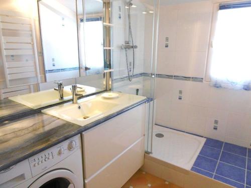 a bathroom with a sink and a washing machine at Appartement 4 à 6 personnes avec vue mer - GWENAEL in Sarzeau