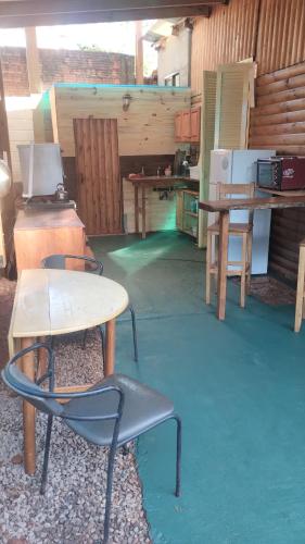 a room with a table and a table and a chair at Casa en Cataratas del Iguazú - GUEST HOUSE - in Puerto Iguazú