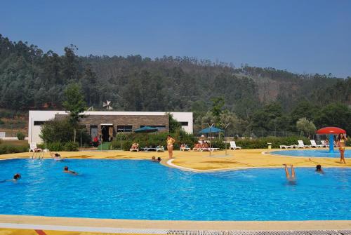 a group of people in a large swimming pool at A Casa da Praça - The Square House in Miranda do Corvo
