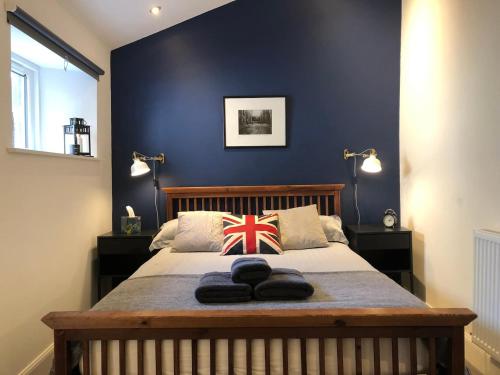 a bedroom with a bed with a british flag pillow at Modern loft style apartment in converted church in Edinburgh