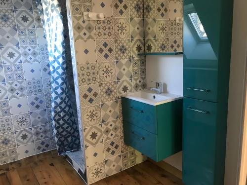a bathroom with a sink and a shower at Appartement duplex 180m² in La Bourboule