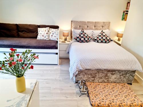a bedroom with a bed and a couch at Morden Place, Free Parking & Private Entrance in Bournemouth