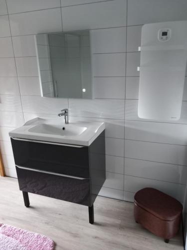 a bathroom with a sink and a mirror at Maison de Lily in Cier-de-Luchon