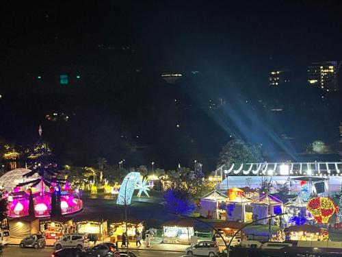 a night time view of a festival with lights at Suite Laghetto EUR in Rome