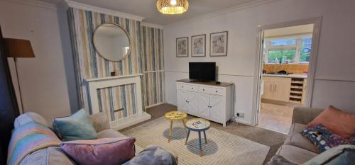 a living room with a couch and a tv at Cavan Crescent in Broadstone